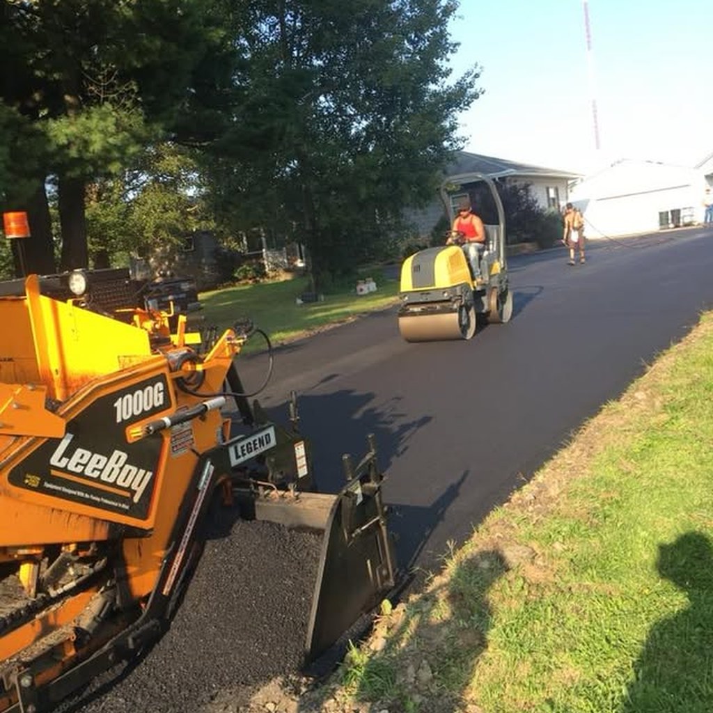 Residential driveway repair with fresh asphalt near Erie, PA